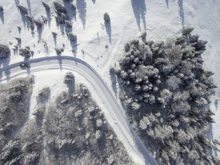 Obraz na płótnie Canvas Aerial images of winter road in a forest