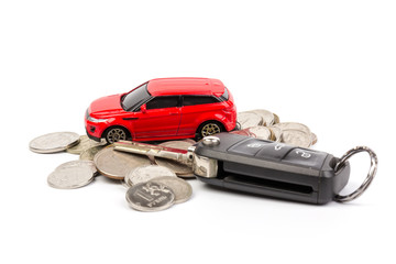 Red car and key with coins. Concept of the automobile loan, saving money for car, trade car for cash, the concept of Finance.