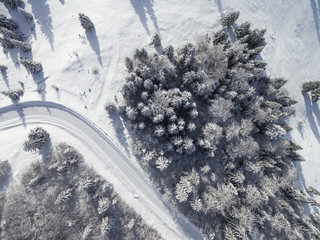Naklejka na ściany i meble Aerial images of winter road in a forest