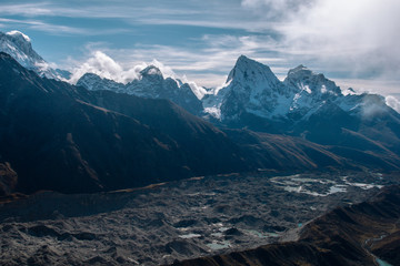 Snow covered beautiful mountain peaks and soft white clouds