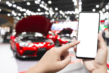 Mockup image of hand holding blank screen mobile and pointing to smart phone with blurred...