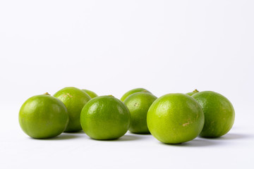 Portrait Of Fresh Green Limes Against White Background