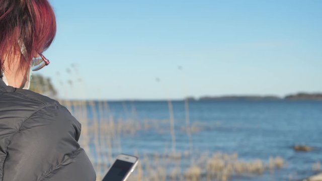 Look of the lady while browsing her phone in Finland 
