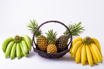 Portrait Of Basket With Pineapples And Bananas On The Side