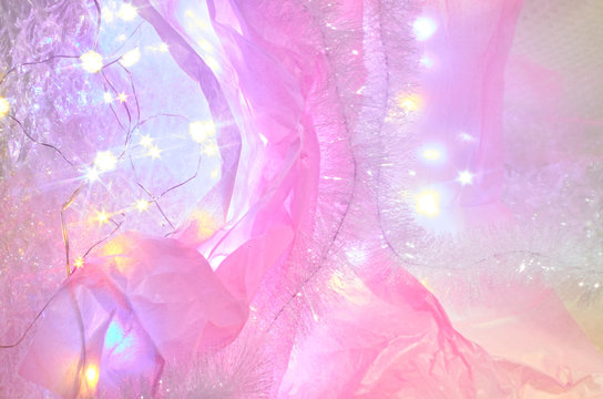 Pink materials with Christmas lights and branch
