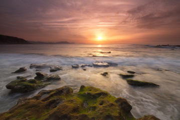 Fototapeta na wymiar Getxo, Bizkaia/Basque Country; May 16, 2012. Colorful sunset at Azkorri beach at low tide