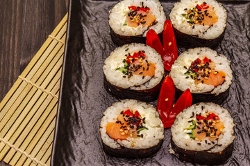 Korean roll Gimbap(kimbob). Steamed white rice (bap) and various other ingredients. Trendy black background