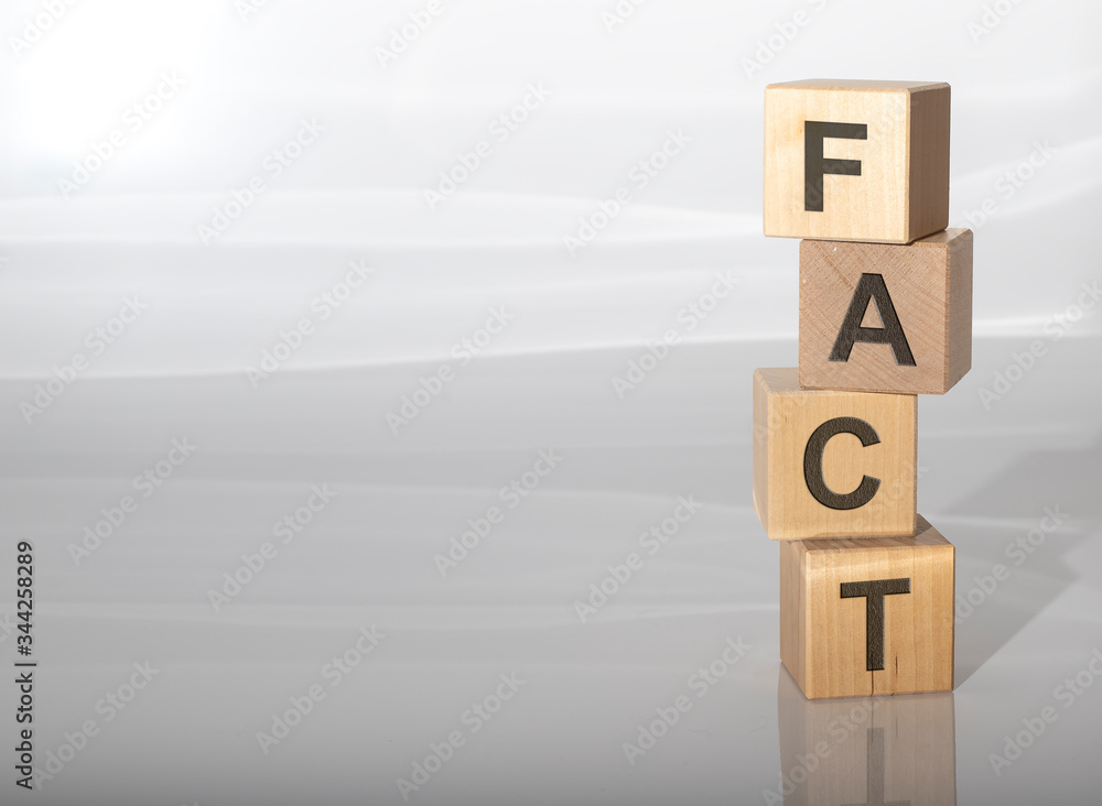 Aufkleber concept word fact on cubes on a grey glossy background with reflection