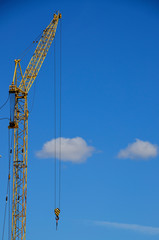 One big construction crane, against the blue sky.