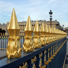 Beautiful Golden Fence Finials disappearing in an angular row