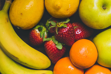 Mix of delicious fruits on the rustic wood table. Perfect mix of colours. Nice to make a salad fruit.