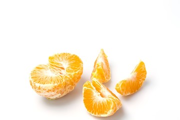 Close up macro view of whole and peeled mandarin on white background. Organic food concept. Healthy food concept. 