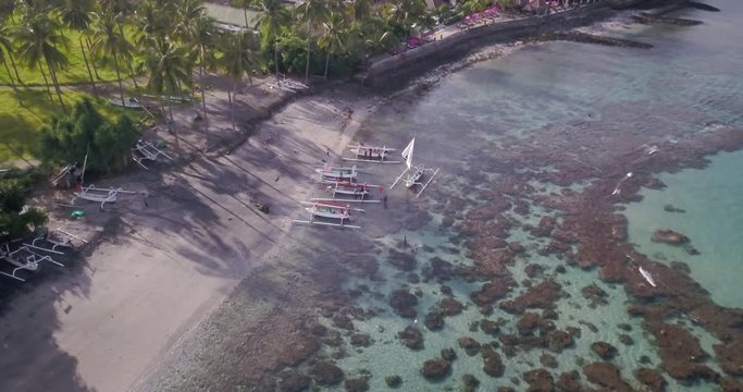 Drone shot of tropical lagoon with crystal water and local fishing boats