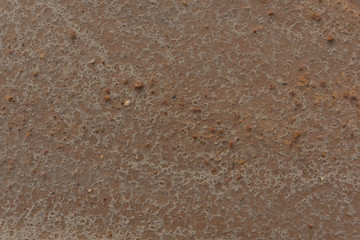 Top view of flat yellow earthy gravel surface texture