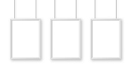 Realistic hanging on a wall white blank picture frame. Modern poster mockup. Empty photo frame. Vector illustration.