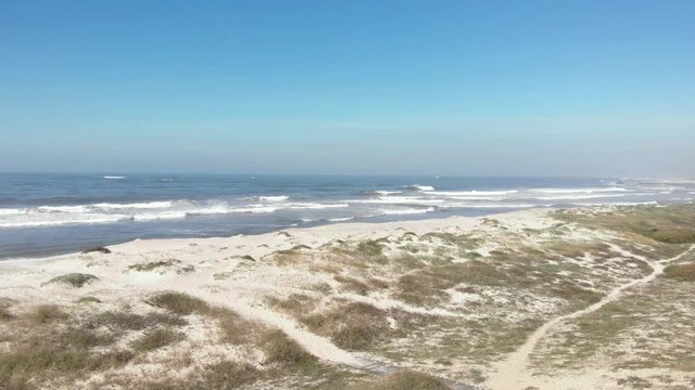 Northern Litoral Natural Park in Ofir, Esposende, Portugal. Sunny beach with sand dunes and blue sky in Esposende, Portugal. Autumn Wind Day.