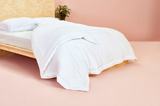 White Comforter On Wooden Bed