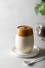 coffee dalgona in a glass on a light background, fashion korean trend. Place for text