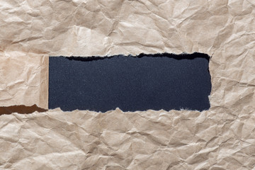 Black hole in craft paper. Rip and torn concept, place for text,