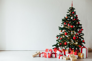 Christmas tree with gifts of red white interior decor for the new year