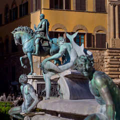 Equestrian statue of Cosimo I de' Medici on the Piazza della Signoria in front of the Palazzo Vecchio. Fountain Neptune on a foreground. Florence, Tuscany, Italy.