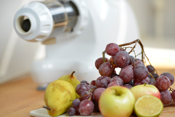 Vitamin C in fruits and vegetables choice just before preparing  Juice with extractor  in white kitchen