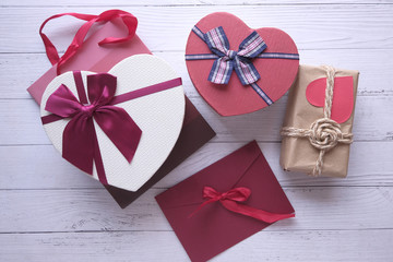 Different colorful gift boxes on wooden background.