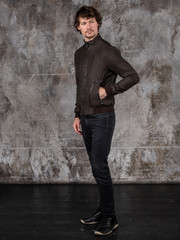 Full length studio portrait of attractive young man. Young Male Fashion Model Posing In Casual Outfit. 