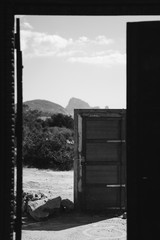 Famous doors in middle of dessert in Ibiza in black and white for dramatic effect