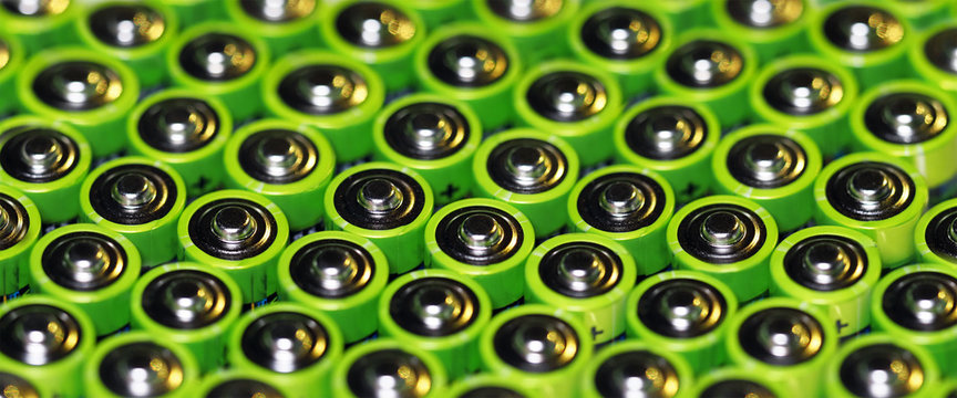 Green batteries, alkaline battery AA size format. Energy abstract background, panoramic view