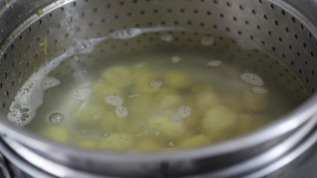 Cooking baroa potato gnocchi in a pan. Boiled Water.