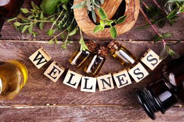 Homegrown and aromatic herbs with rosemary and basil. Wellness sign with wooden cubes