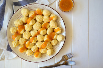 Home made sweet cottage cheese lazy dumplings (vareniki) with apricot jam on top.