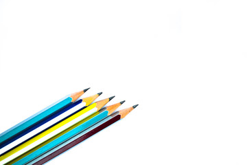 Fototapeta premium Some different colored wood pencil crayons arranged on a white background