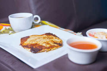 Photo of pupusas dish on couch with center console