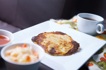Photo of pupusas dish on couch with center console