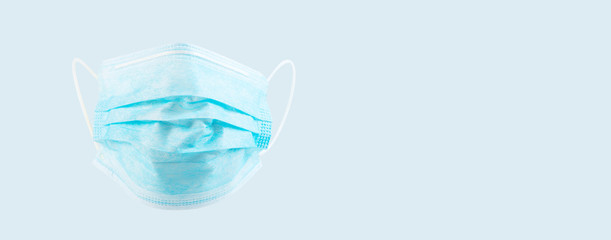 Protecting disposable doctors mask face isolated on blue background. Antiviral safety face masks. Protection against flu and coronavirus, pollution, virus. Personal hygiene product. banner