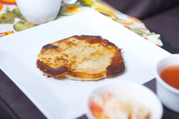 Photo of pupusas dish on couch with center console