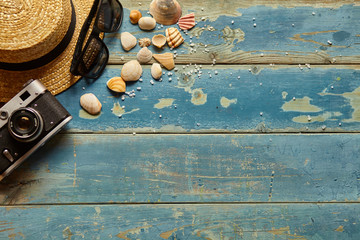 beach and traveler accessories on blue wooden board