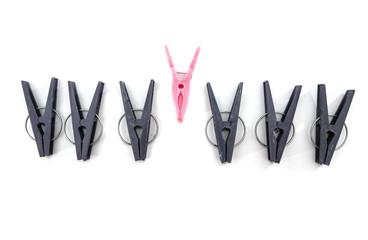 Clothespin clips on isolated white background - Leadership ideas and concepts