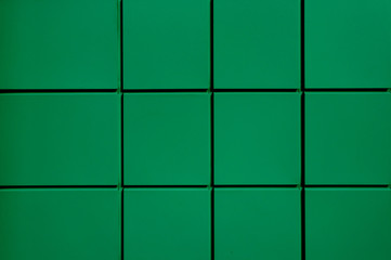 The texture of the metallic green facade of the squares. Green metal facade.