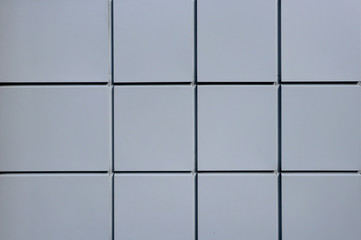 The texture of the metallic gray facade of the squares. Gray metal facade.
