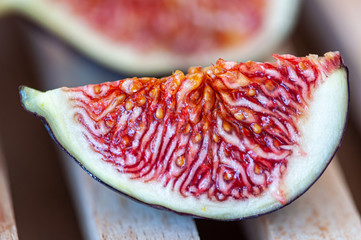 Fresh fig fruit on a wooden cutting board.