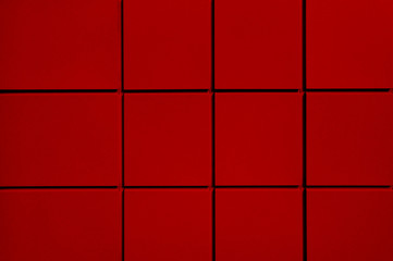 Red metal building facade. Red background from square geometric shapes. Geometric figures