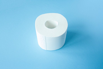 Toilet paper roll on a blue background top view. Toilet paper purchase due to kronavirus concept. Personal hygiene and stopping the spread of the virus. Cleanliness, Hygiene, Sterility