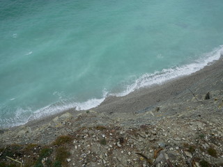 Empty sea shore with a pier on a spring sunny day