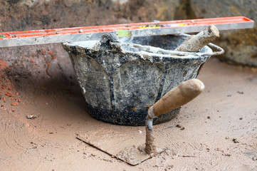 Construction tools background, bucket trowel and level .