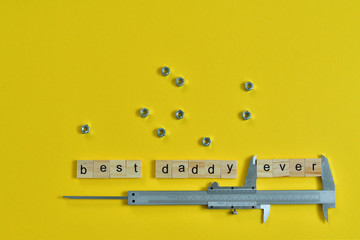 Inscription Fathers Day with different tools on yellow background. Wooden letter BEST DADDY EVER...
