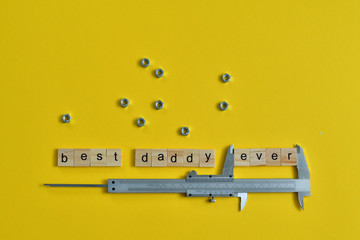 Inscription Fathers Day with different tools on yellow background. Wooden letter BEST DADDY EVER...
