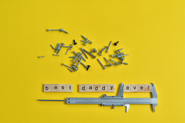 Inscription Fathers Day with different tools on yellow background. Wooden letter BEST DADDY EVER...